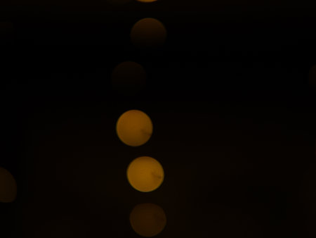 Golden and dark brown round bokeh lights festive background . High quality photoの写真素材