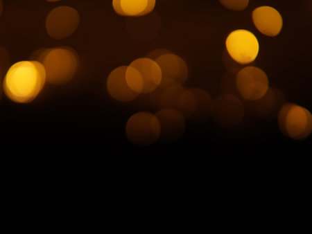 Golden and dark brown round bokeh lights festive background . High quality photoの写真素材