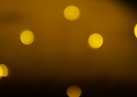 Golden and dark brown round bokeh lights festive background . High quality photoの写真素材
