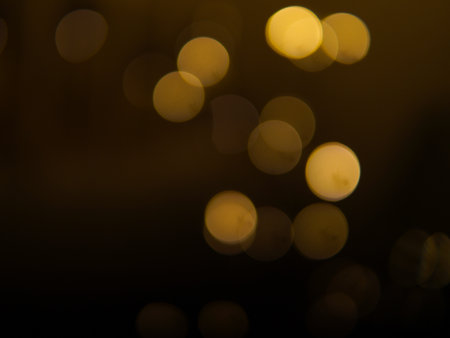 Golden and dark brown round bokeh lights festive background . High quality photoの写真素材