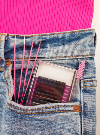 Staff for eyelash extensions in beauty salon, pink equipment for beauticians . High quality photoの写真素材