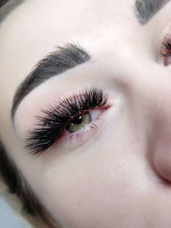 Close up of eye with eyelash Extensions in beauty salon, mega russian volume,l curl. High quality photoの写真素材