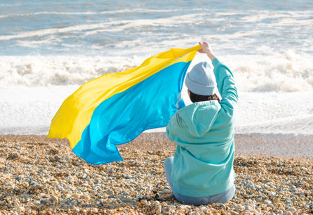 brunnete woman wearing in blue hoodie and blue hat with national flag of Ukraine,patriotic conceptの写真素材