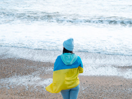 brunnete woman wearing in blue hoodie and blue hat with national flag of Ukraine,patriotic conceptの写真素材