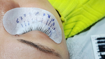 close up of eye with eyelash extension macro view,beauty salon treatment.lash scheme on patchの写真素材