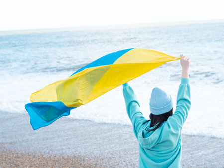 brunnete woman wearing in blue hoodie and blue hat with national flag of Ukraine,patriotic conceptの写真素材