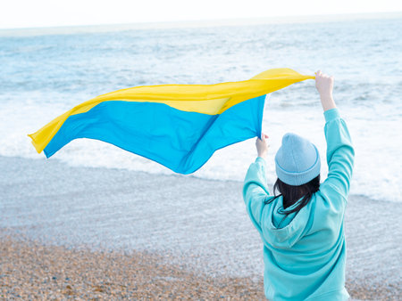 brunnete woman wearing in blue hoodie and blue hat with national flag of Ukraine,patriotic conceptの写真素材