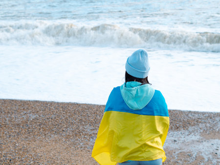 brunnete woman wearing in blue hoodie and blue hat with national flag of Ukraine,patriotic conceptの写真素材