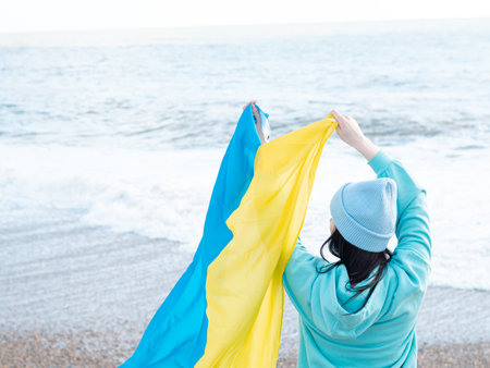 brunnete woman wearing in blue hoodie and blue hat with national flag of Ukraine,patriotic conceptの写真素材