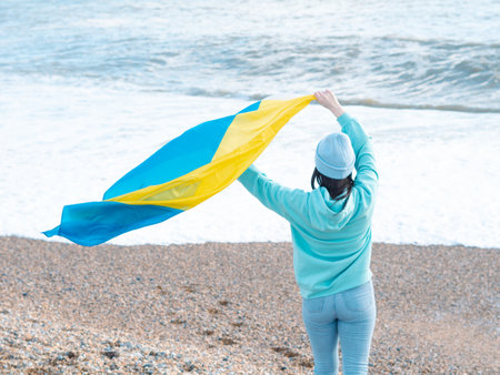 brunnete woman wearing in blue hoodie and blue hat with national flag of Ukraine,patriotic conceptの写真素材