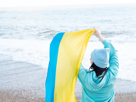 brunnete woman wearing in blue hoodie and blue hat with national flag of Ukraine,patriotic conceptの写真素材