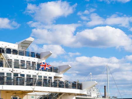 britain flag waving in blue sky background union jackの写真素材