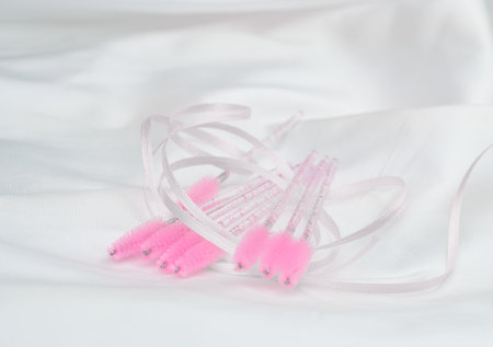 close up of pink brushes for combing eyelash extensions and brows,tool for treatment in beauty salon.の写真素材