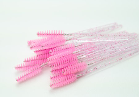 close up of pink brushes for combing eyelash extensions and brows,tool for treatment in beauty salon.の写真素材