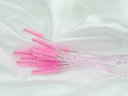 close up of pink brushes for combing eyelash extensions and brows,tool for treatment in beauty salon.の写真素材