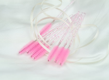 close up of pink brushes for combing eyelash extensions and brows,tool for treatment in beauty salon.の写真素材