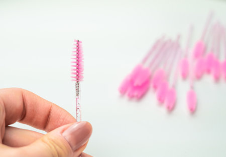 close up of pink brushes for combing eyelash extensions and brows,tool for treatment in beauty salon.の写真素材
