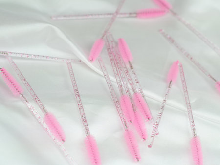 close up of pink brushes for combing eyelash extensions and brows,tool for treatment in beauty salon.の写真素材