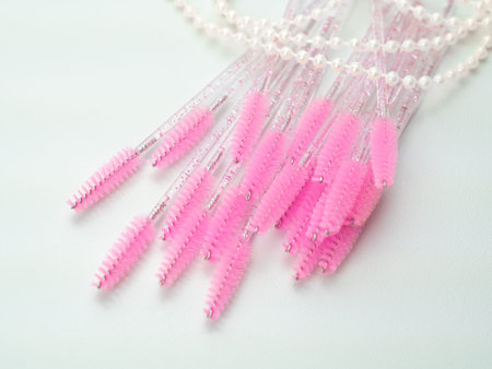 close up of pink brushes for combing eyelash extensions and brows,tool for treatment in beauty...