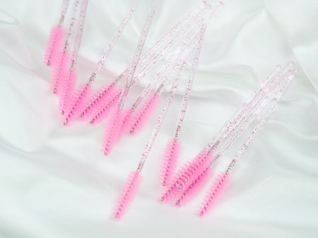 close up of pink brushes for combing eyelash extensions and brows,tool for treatment in beauty salon.の写真素材
