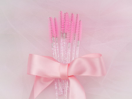 close up of pink brushes for combing eyelash extensions and brows,tool for treatment in beauty salon.の写真素材