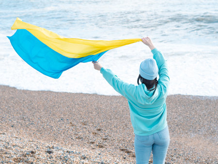 brunnete woman wearing in blue hoodie and blue hat with national flag of Ukraine,patriotic conceptの写真素材
