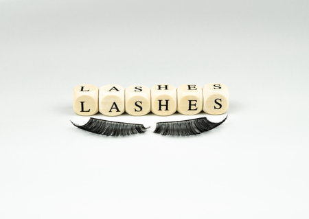 inscriptions lashes on wooden beads,beauty salon treatment concept.lash extensionsの写真素材