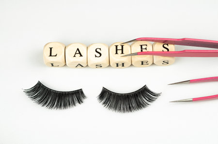 inscriptions lashes on wooden beads,beauty salon treatment concept.lash extensionsの写真素材