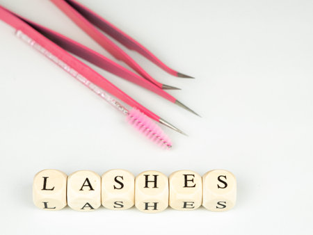 inscriptions lashes on wooden beads,beauty salon treatment concept.lash extensionsの写真素材