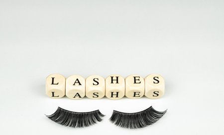 inscriptions lashes on wooden beads,beauty salon treatment concept.lash extensionsの写真素材