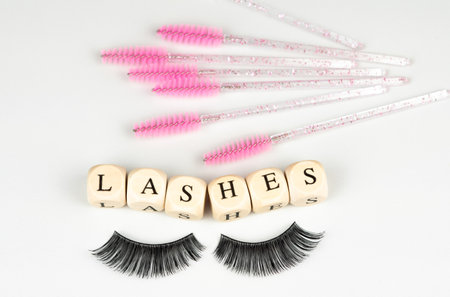 inscriptions lashes on wooden beads,beauty salon treatment concept.lash extensionsの写真素材
