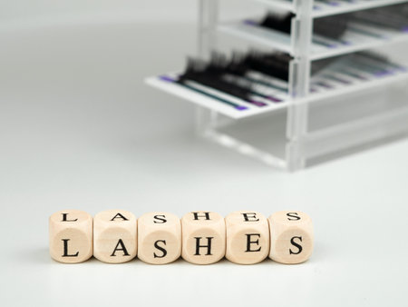 inscriptions lashes on wooden beads,beauty salon treatment concept.lash extensionsの写真素材