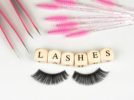 inscriptions lashes on wooden beads,beauty salon treatment concept.lash extensionsの写真素材