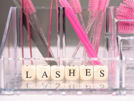 inscriptions lashes on wooden beads,beauty salon treatment concept.lash extensionsの写真素材
