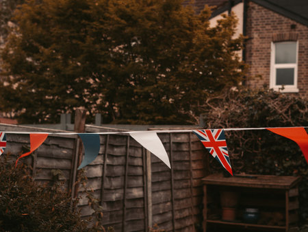 Flags of Great Britain waving on the wind in the garden of English house,coronation celebration .の写真素材