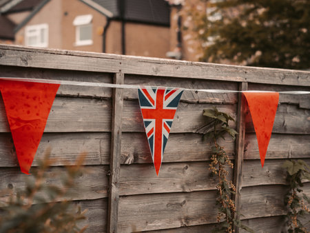 Flags of Great Britain waving on the wind in the garden of English house,coronation celebration .の写真素材
