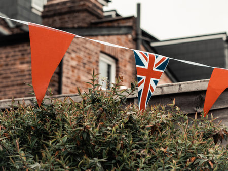 Flags of Great Britain waving on the wind in the garden of English house,coronation celebration .の写真素材