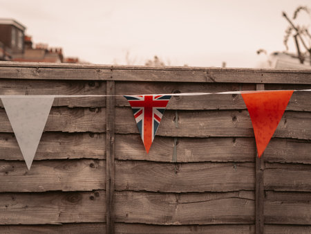 Flags of Great Britain waving on the wind in the garden of English house,coronation celebration .の写真素材