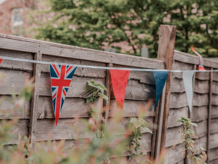 Flags of Great Britain waving on the wind in the garden of English house,coronation celebration .の写真素材