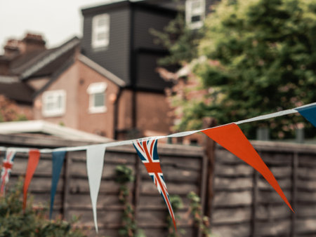 Flags of Great Britain waving on the wind in the garden of English house,coronation celebration .の写真素材