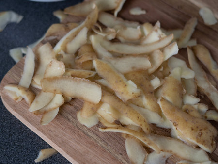 raw potatoes with peeled skin on the wooden desk on the table. High quality photoの写真素材