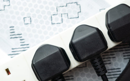 close up of english socket in the wall, electricity bills
