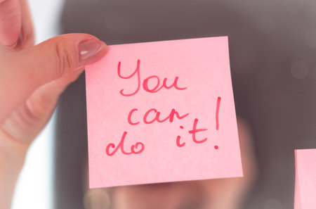 inspirational quotes on pink sticker on the mirror,handwriting text.の写真素材
