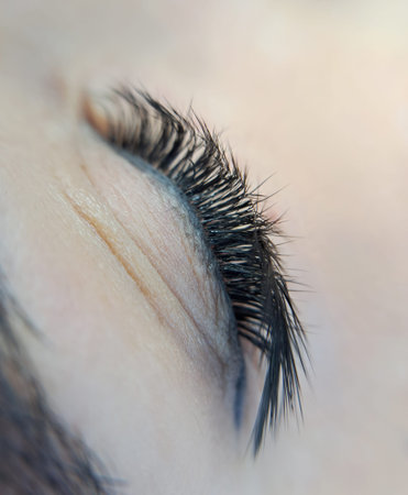 close up of eye with eyelash extensions in beauty salon macro eye