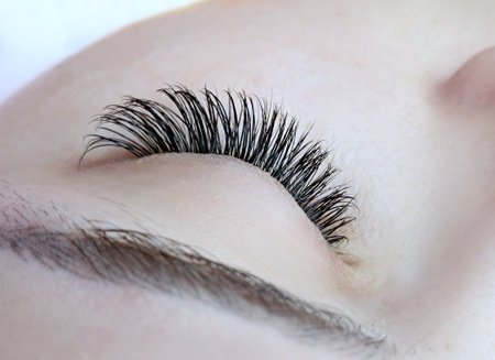 Close up of eye with eyelash extensions ,beauty salon treatment ,2d volume, 3d volume, classical lashes,Russian volume,megavolume, new set.の写真素材