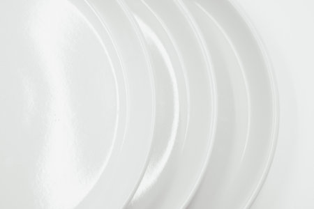 White round plate on white background copy space . High quality photoの写真素材