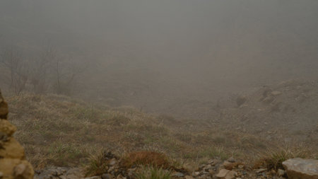 Fog envelops majestic mountain peaks, creating a mystical and serene landscapeの写真素材