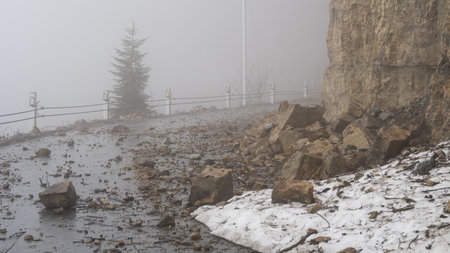 Fog envelops majestic mountain peaks, creating a mystical and serene landscapeの写真素材