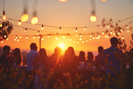..A garden summer party at sunset, with silhouettes against the colorful skyの素材