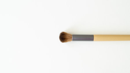 Wooden organic makeup brushes on white backdrop. Eco-friendly, sustainable beauty tools.の写真素材
